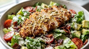 Ultra close-up macro of crispy garlic parmesan chicken bacon salad with creamy dressing
